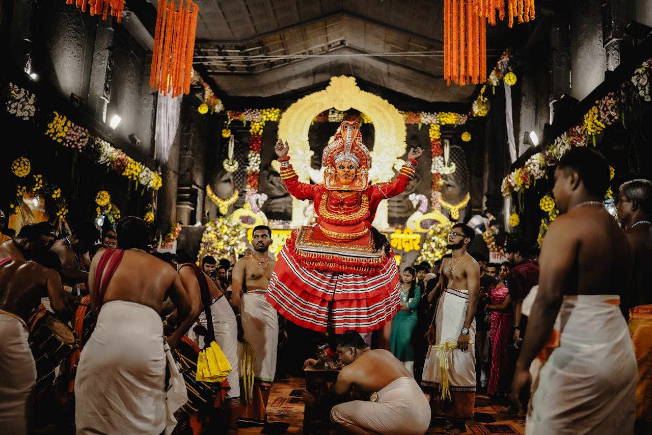 A vibrant Theyyam performance inside a decorated temple in Nagpur, Maharashtra, India.